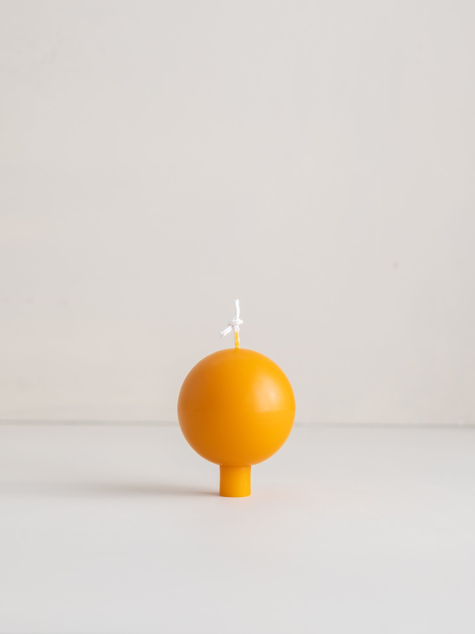 Beeswax footed sphere candle